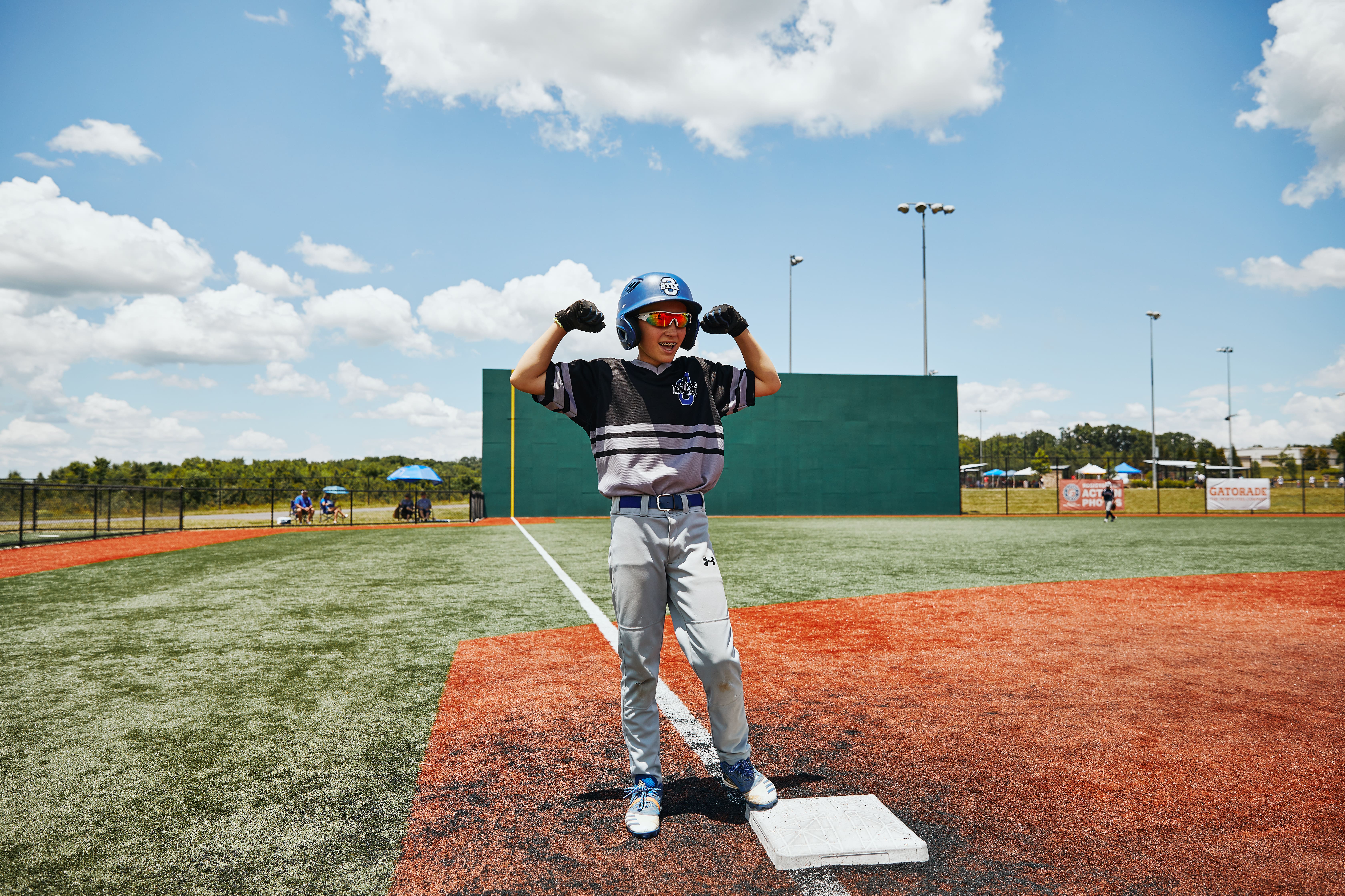 Player flexing in front of the green monster at The Ripken Experience™ Pigeon Forge